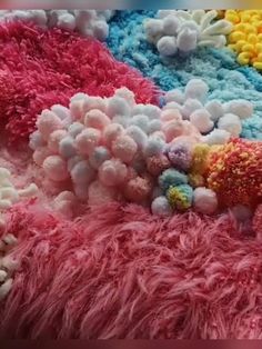 the colorful carpet is covered with pom poms