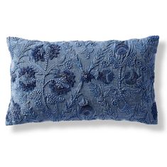 a blue decorative pillow on a white background