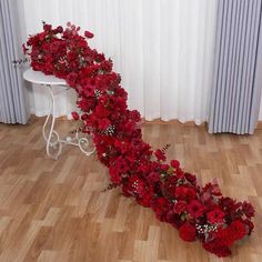 red flowers are arranged in the shape of a long ribbon