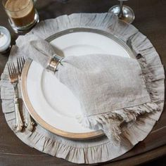 a table setting with silverware and napkins