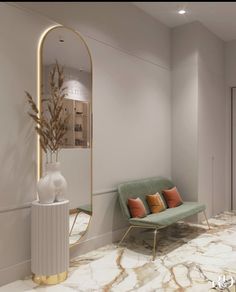 a living room with marble flooring and gold accents on the walls, along with a green couch