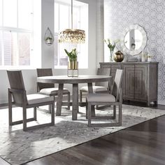 a dining room table with four chairs around it