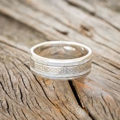 a wedding ring sitting on top of a wooden table