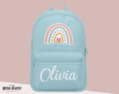 Here We Have For Sale A Gorgeous New Style Backpack. Ideal For New School Starters Or Your Child Starting The New Term In Style. The Bag Is Personalised With Your Child's Name Printed On The Pocket With a Rainbow Above It. Our Personalised Items Make Great Gifts, And If You're Looking For Personalised Gifts You're In The Right Place. Mini Backpack Features: ►Fully adjustable shoulder straps grow with your child  ►Zippered front pocket great for pencil cases and accessories ►Padded back panel for maximum comfort ►Grab handle on top ►Dimensions: 23 x 35 x 12cm ►Capacity: 7 litres Customizable Blue School Bag, Customizable Blue Standard Backpack, Cute Customizable Backpack, Rainbow Backpack, Nursery Bag, Personalized Backpack, School Bags For Girls, Girls School, Pencil Cases