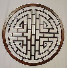 a circular design with an arrow in the center on a white wallpapered surface