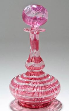 a pink glass vase sitting on top of a table