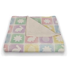 a blanket with an animal pattern on it and a white towel folded over the top