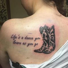 a woman with a tattoo saying life is a dance you learn as you go on