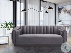 a gray couch sitting in front of a window