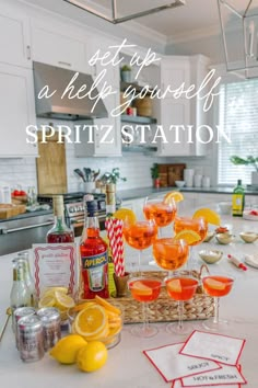 a kitchen counter topped with glasses filled with drinks