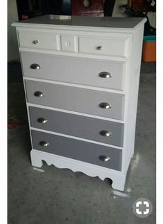 a white and grey chest of drawers in a room