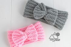 two crocheted headbands with bows on the top, one in grey and one in pink