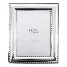 a silver frame with beading on the edges and an inscription that reads lunt