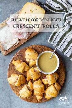 chicken cordon bleu crescent rolls on a wooden plate next to a bowl of gravy