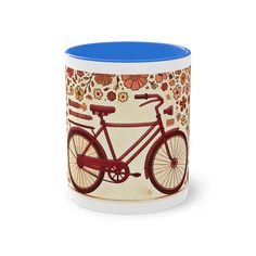 a coffee mug with a bicycle painted on the front and bottom, sitting in front of a white background