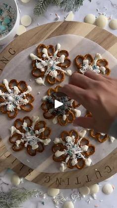 someone is decorating some pretzels on a board