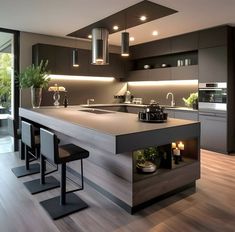 a modern kitchen with an island counter and bar stools in the center, lighted by recessed lighting