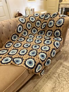 a couch with a crocheted blanket on it