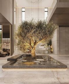 a large tree in the middle of a room with stairs and chandelier above it