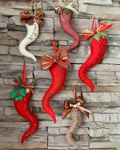 four christmas stockings hanging on a stone wall