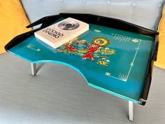 a coffee table with a book on it and a camera sitting on top of it