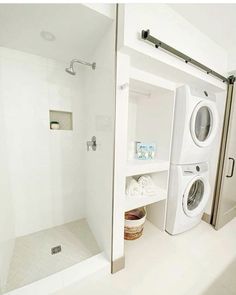 a washer and dryer in a white bathroom