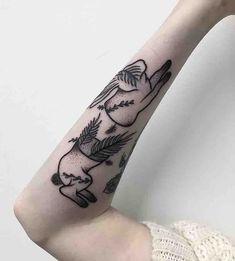 a woman's arm with an elephant tattoo on the left side of her arm