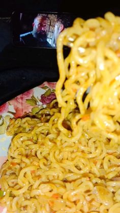 noodles being cooked on a plate with chopsticks