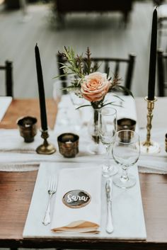 the table is set with candles and place settings