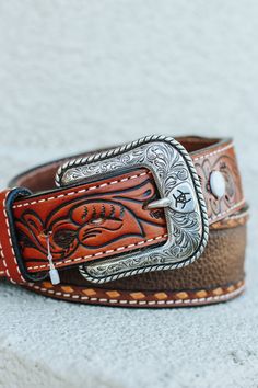 Mens Ariat Belt: Mens Ariat Western Belt. This Ariat men’s belt by M&F Western Products is made with genuine leather. It has hand tooled floral tabs with contrast buck lacing and a brown rowdy leather inlay. The buckle is removable and it is 1 1/2" wide. Cowboy Belt Buckles Men, Mens Tooled Leather Belt, Western Leather Embossed Belt Buckles, Western Style Brown Belt With Engraving, Engraved Leather Western Belt, Ariat Belts, Men’s Tooled Leather Belt, Belt Buckles Men's, Cowboy Belt Buckles