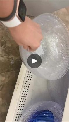 a person is opening up a plastic container