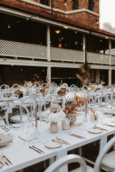 the tables are set with white linens and place settings