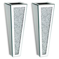 two tall white vases with silver glitter on them