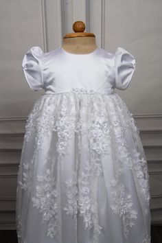 Christening gown for baby girls Gown length: 31 inches Color: white Embroidery: Beads and 3d flowers Fabric: Lace and Satin Underlay - 2 layers, satin and cotton Weight - Lightweight Sleeve - Puff sleeves Features - Floral accents on the waistline, zip closure at the back Please note: Dry clean only. Caremour promises - 1) Stress free shipping guarantee - Free expedited international shipping - Offer applicable Worldwide. Typical shipping time: 3-7 days 2) No surprise guarantee - Rest assured th Elegant Lace First Communion Dress With Floral Applique, White Princess Dress With Floral Applique For First Communion, Pageant Baptism Dress With Floral Applique, White Lace First Communion Dress With Floral Applique, Organza Baptism Dress With Lace Bodice For First Communion, Elegant Floral Applique Dress For Baptism, White Floral Applique First Communion Dress, Lace Princess Dress With Floral Applique For Baptism, White Floral Embroidered Dress For Baptism