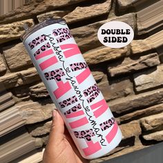 a hand holding up a pink and black leopard print tumbler cup with the words double sided on it