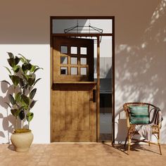 a wooden door sitting next to a potted plant