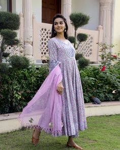 This is a 3-piece set. It comes with soft cotton hand block print anarkali kurta with 32 kali, round neck, 3/4th bell sleeves ankle length.The set also comes with handblock print pants with semi elasticated waistband and kota doria dupatta with gota detailing. Color-Pink & Purple Kurta Fabric-Soft Cotton Bottom Fabric-Cotton Dupatta Fabric-Kota Doria Work-Block Print Neck-Round Neck Sleeves-3/4th Bell Sleeves Washing Care-Dry Clean Only Cotton Anarkali Set With Floral Print For Festivals, Festive Cotton Anarkali Set With Floral Print, Cotton Anarkali Set With Floral Print For Diwali, Diwali Cotton Anarkali Set With Floral Print, Cotton Anarkali With Floral Print, Cotton Anarkali Traditional Wear With Floral Print, Anarkali Cotton Salwar Kameez With Floral Print, Cotton Ankle-length Sets For Navratri, Ankle-length Cotton Sets For Navratri