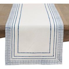 a white table runner with blue stitching on the edges and border at the top