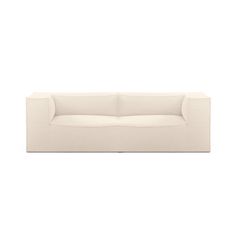 a white couch sitting on top of a white floor