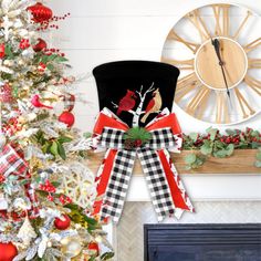 a decorated christmas tree in front of a clock