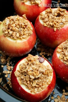 apples with granola in them sitting on a plate