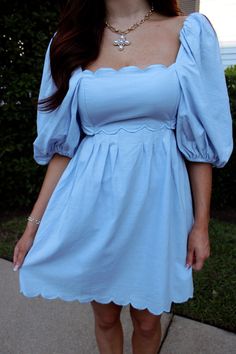 Blue puff sleeve mini dress with scallop edged detail. Light Blue Mini Dress With Ruffle Hem, Light Blue Square Neck Mini Dress With Ruffles, Light Blue Mini Dress With Ruffles And Square Neck, Blue Mini Dress With Ruffle Hem And Square Neck, Ruffled Puff Sleeve Mini Dress, Blue Puff Sleeve Knee-length Dress With Ruffles, Ruffled Mini Length Puff Sleeve Dress, Solid Color Mini Puff Sleeve Dress With Ruffles, Mini Length Puff Sleeve Dress With Ruffles