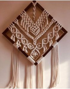 a wall hanging with tassels on it