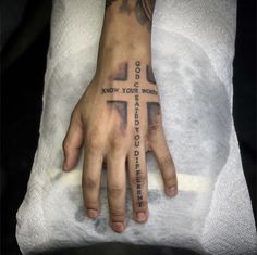 a person with a cross tattoo on their hand