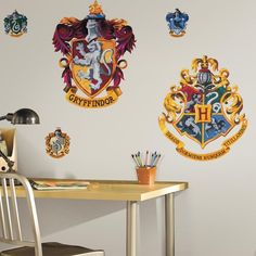 the hogwarts crest wall decals are on display in an office space with a desk and chair