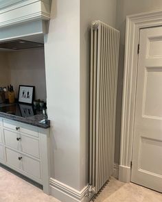 a large white radiator sitting next to a kitchen counter