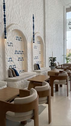 the interior of a restaurant with white walls and blue accents