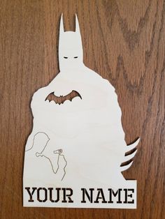 a wooden sign with the words, your name is batman on it and an image of a bat