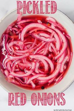 pickled red onions in a white bowl with the words pickled red onions above it