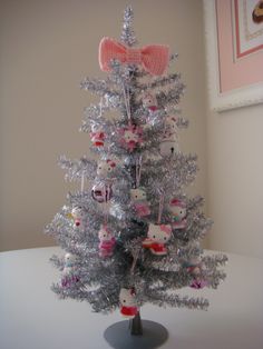 a white christmas tree with hello kitty decorations